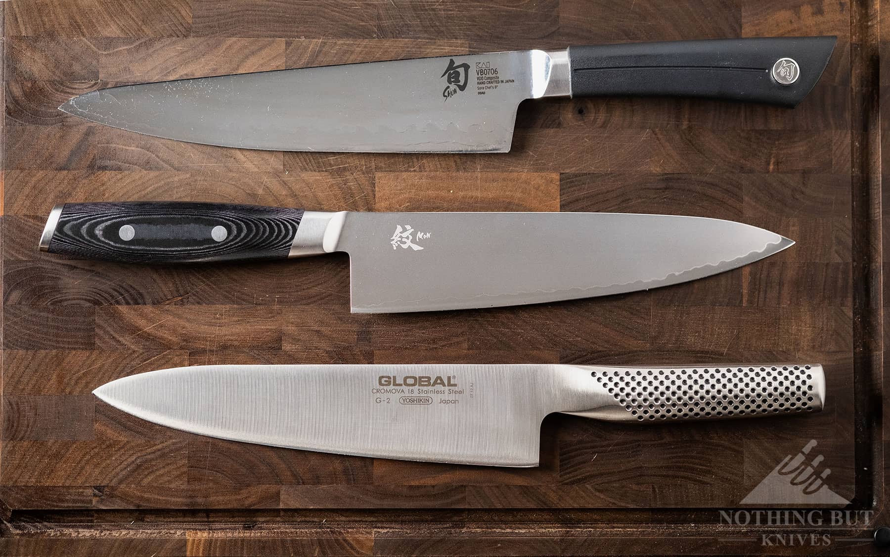 The Yaxel Mon and Shun Sora chef knives are two competaters of the Global G-2 chef knife. All three knives are shown in this image.