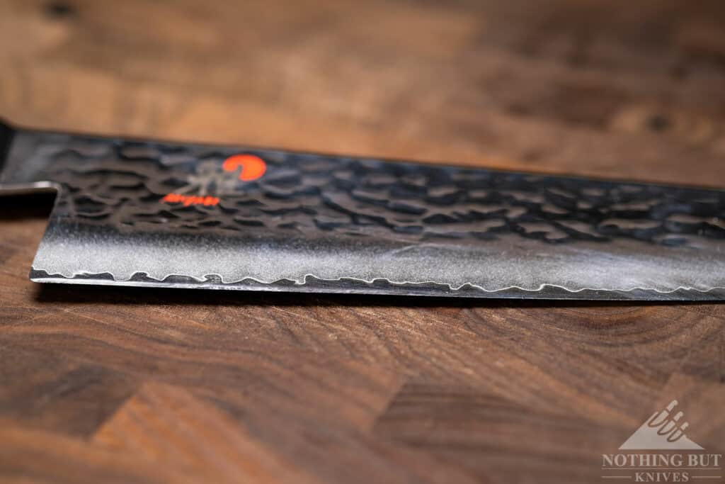 This close-up of the Miyabi SG2 8 inch chef knife blade edge shows how far back the edge curves.