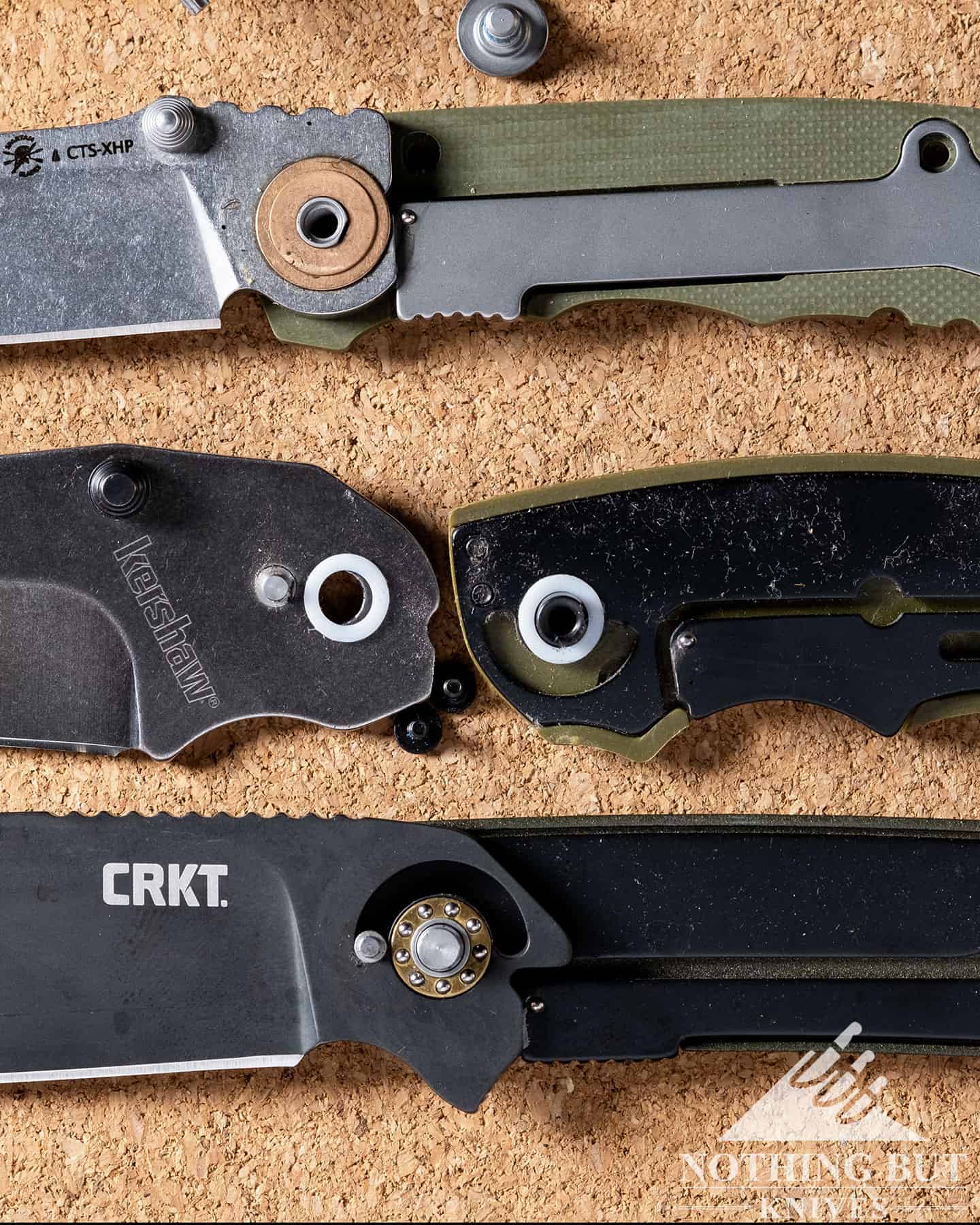 Three different disassembled pocket knives with three different pivot types.
