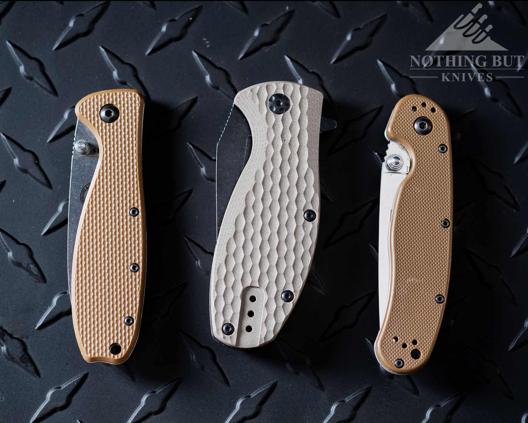 Three folding knives with textured G10 handle scales for better grip.