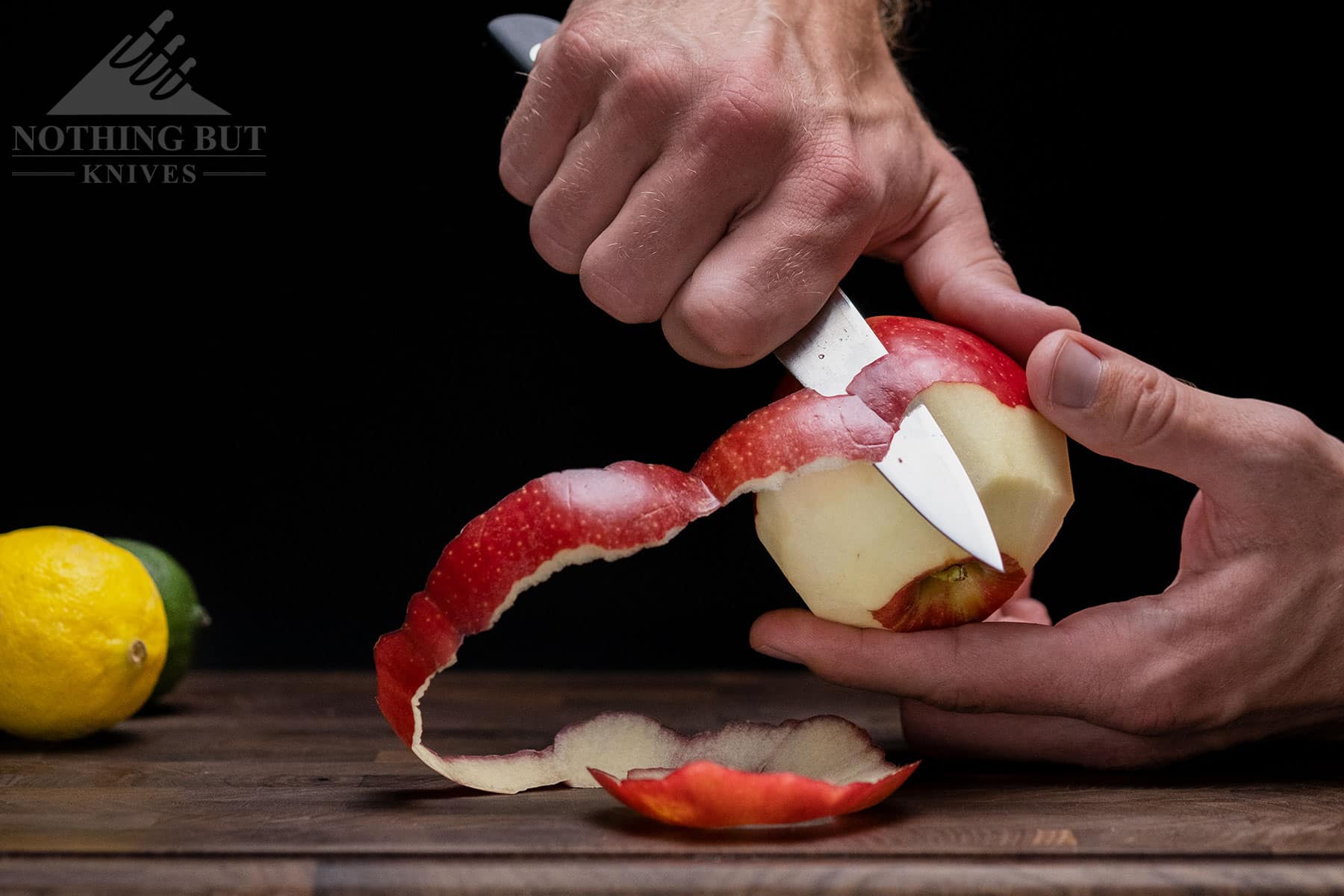 A close-up of the Tojiro DP paring knife to show its peeling ability and ergonomic handle.