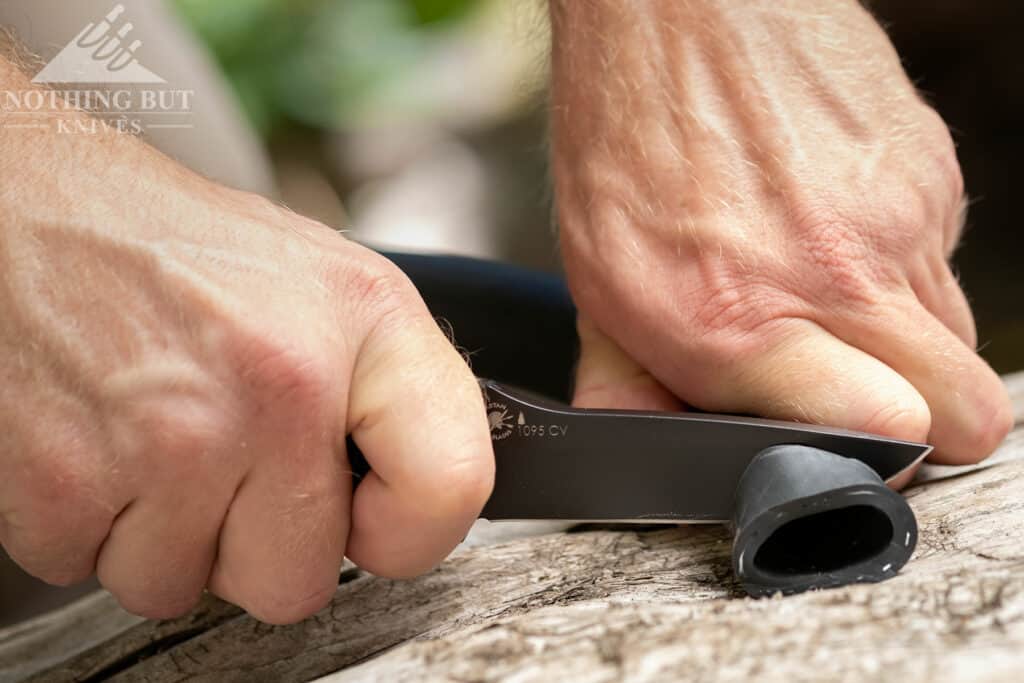 Spartan Blades Alala Knife Review - Image 4 This image of the Alala cutting a rubber tube illustrates the slicing problems associated with the knife's thick edge.