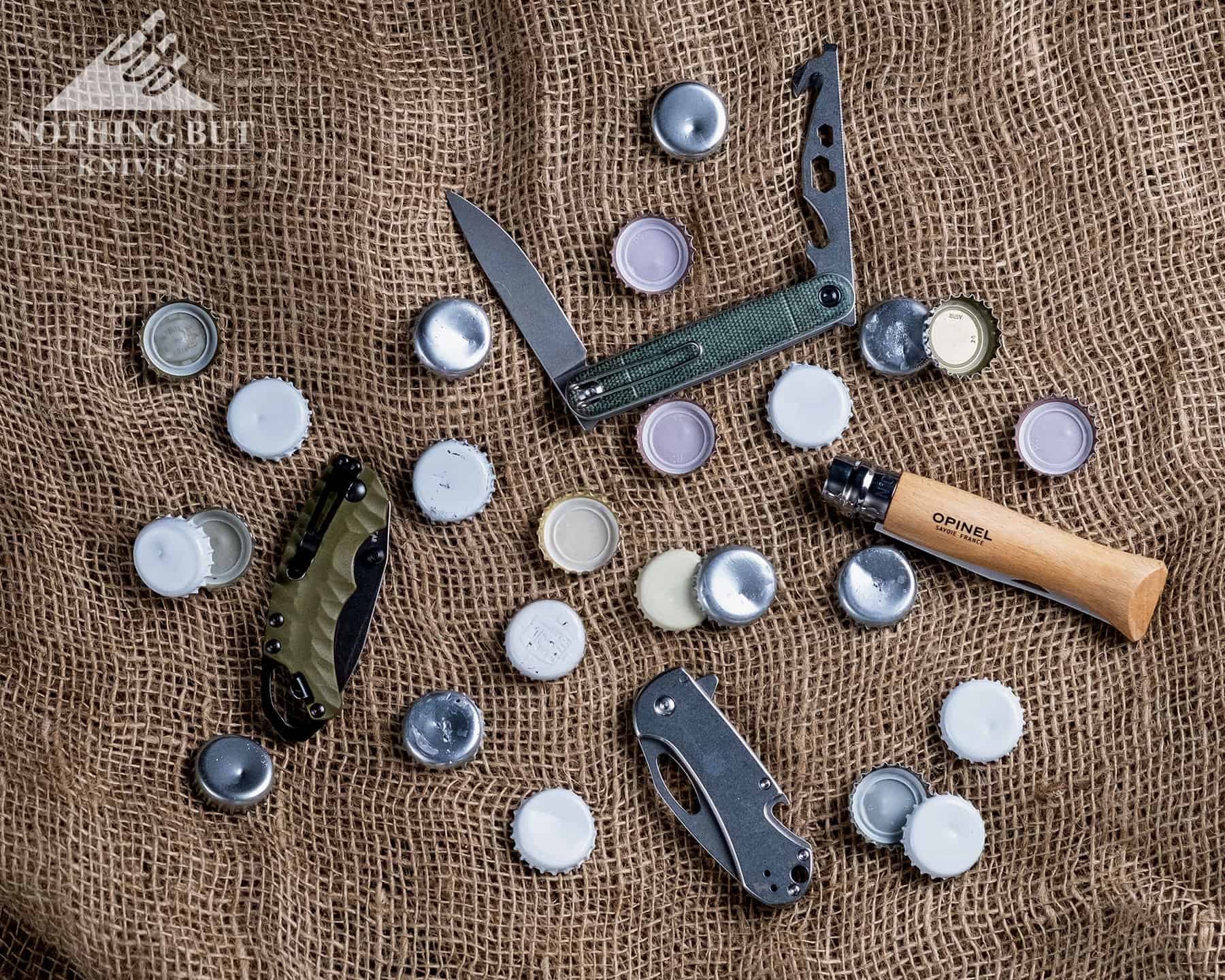 Our Favorite Knives For Opening Beers - Image 1 A few of the best knives with bottle openers surrounded by beer bottle caps.