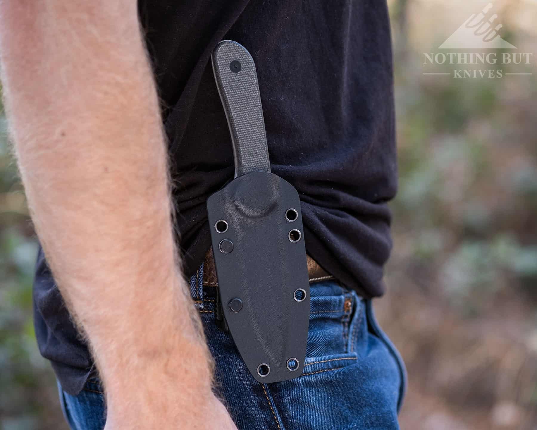 A close-up of the Elementum in its kydex sheath on a persons belt.
