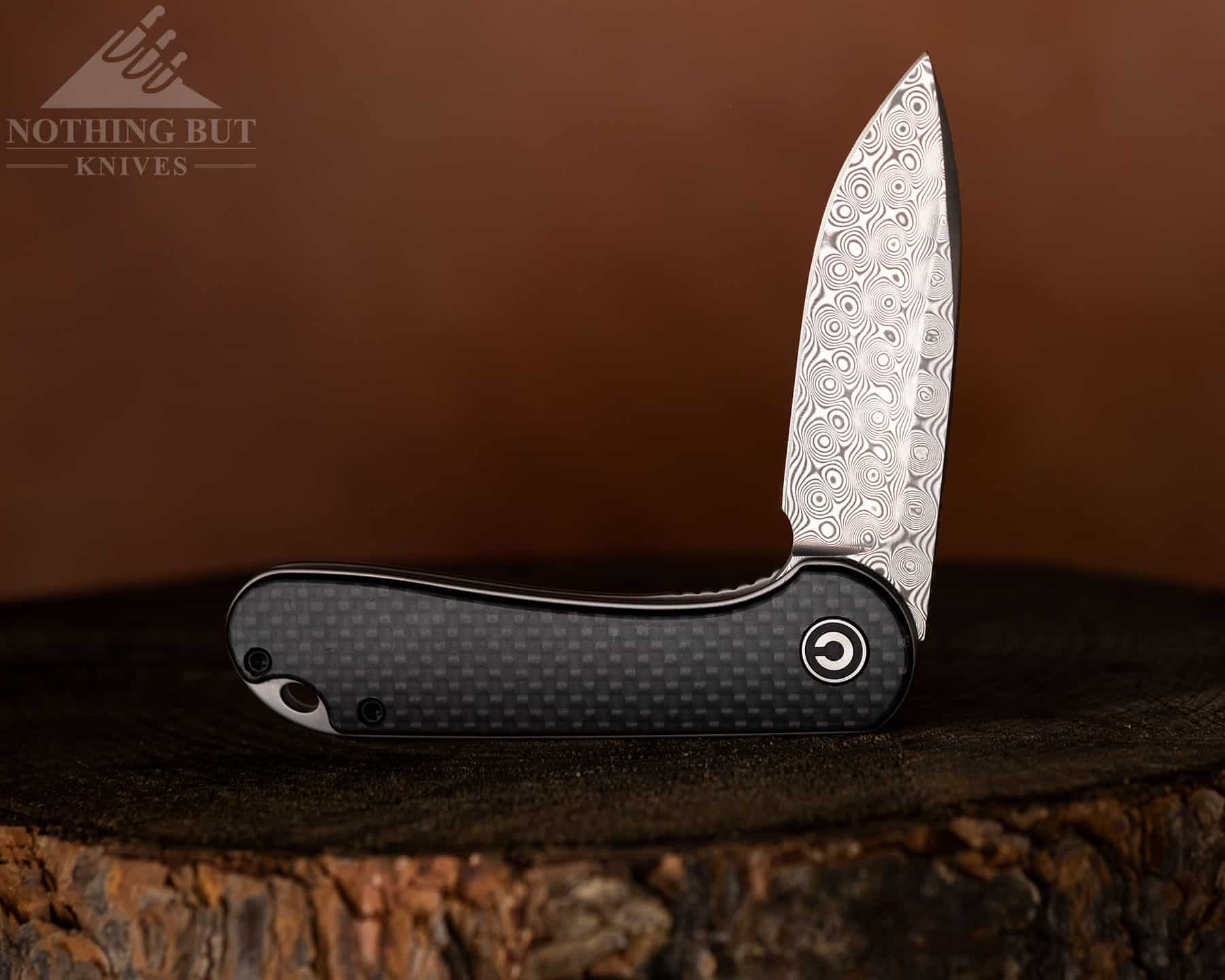 The Civivi Elementum with carbon fiber handle scales and a Damascus steel blade.carbon fiber D
