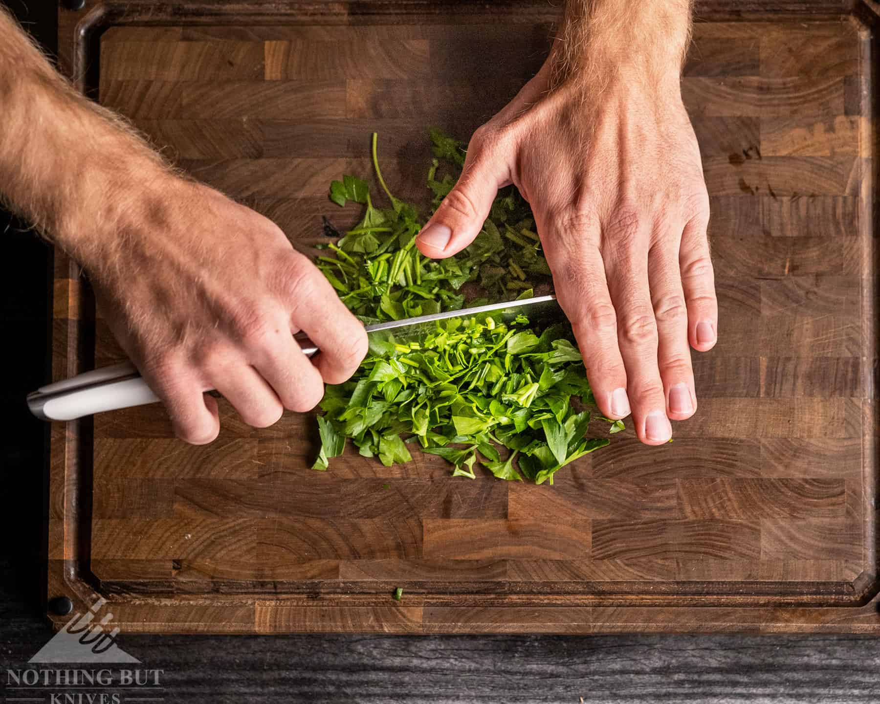 The Cangshan Thomas Keller chef knife would be better for slicing cilantro and other herbs if the edge were polished.