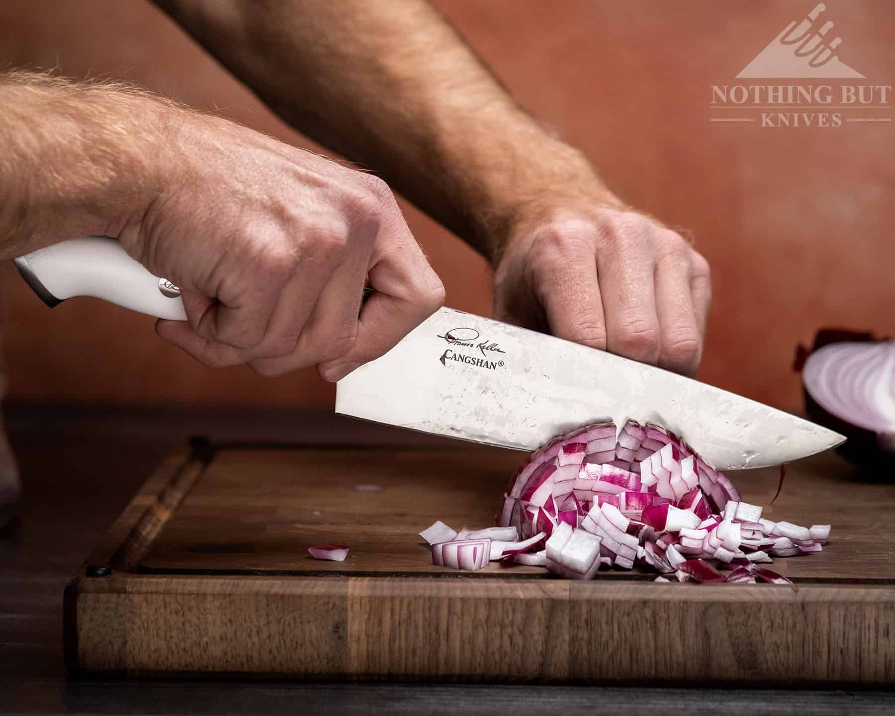 The Cangshan Thomas Keller Signature Collection chef knife cuts effortlessly though onions. 