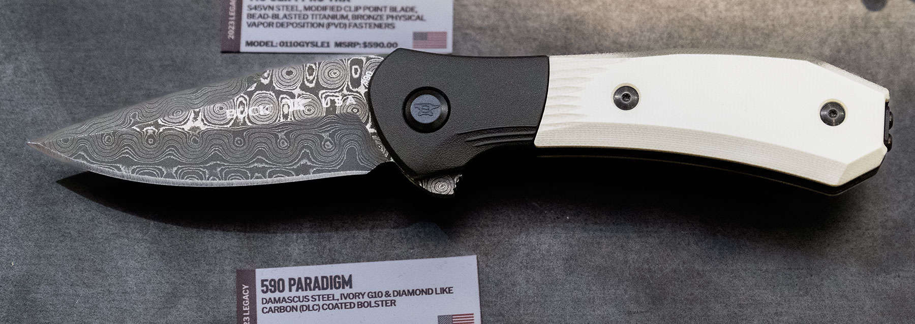 Shot Show 2023 Day 3 - Image 4 The Buck Paradigm in raindrop Damascus and ivory G10 scales.