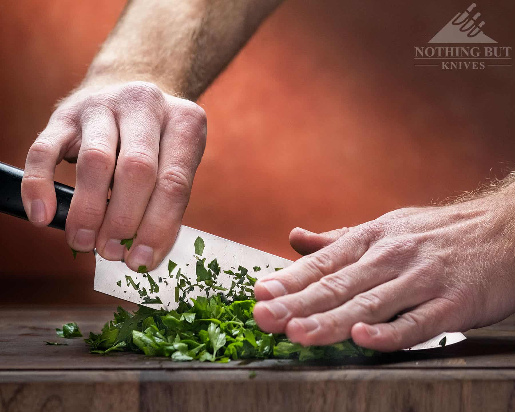 The tall balde of the Cutluxe Artisan chef knife makes rock chopping easy. 