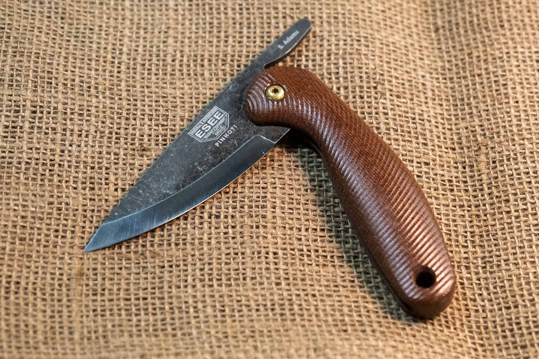 The Esee Pinhoti with G10 handle scales and a 1095 steel blade. 