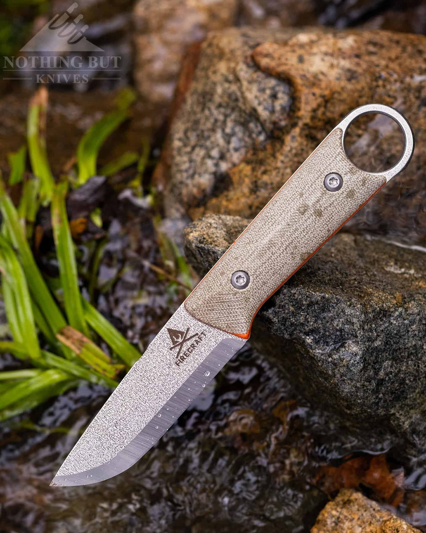 The left side of the White River's handle has a solid slab of orange-lined micarta.