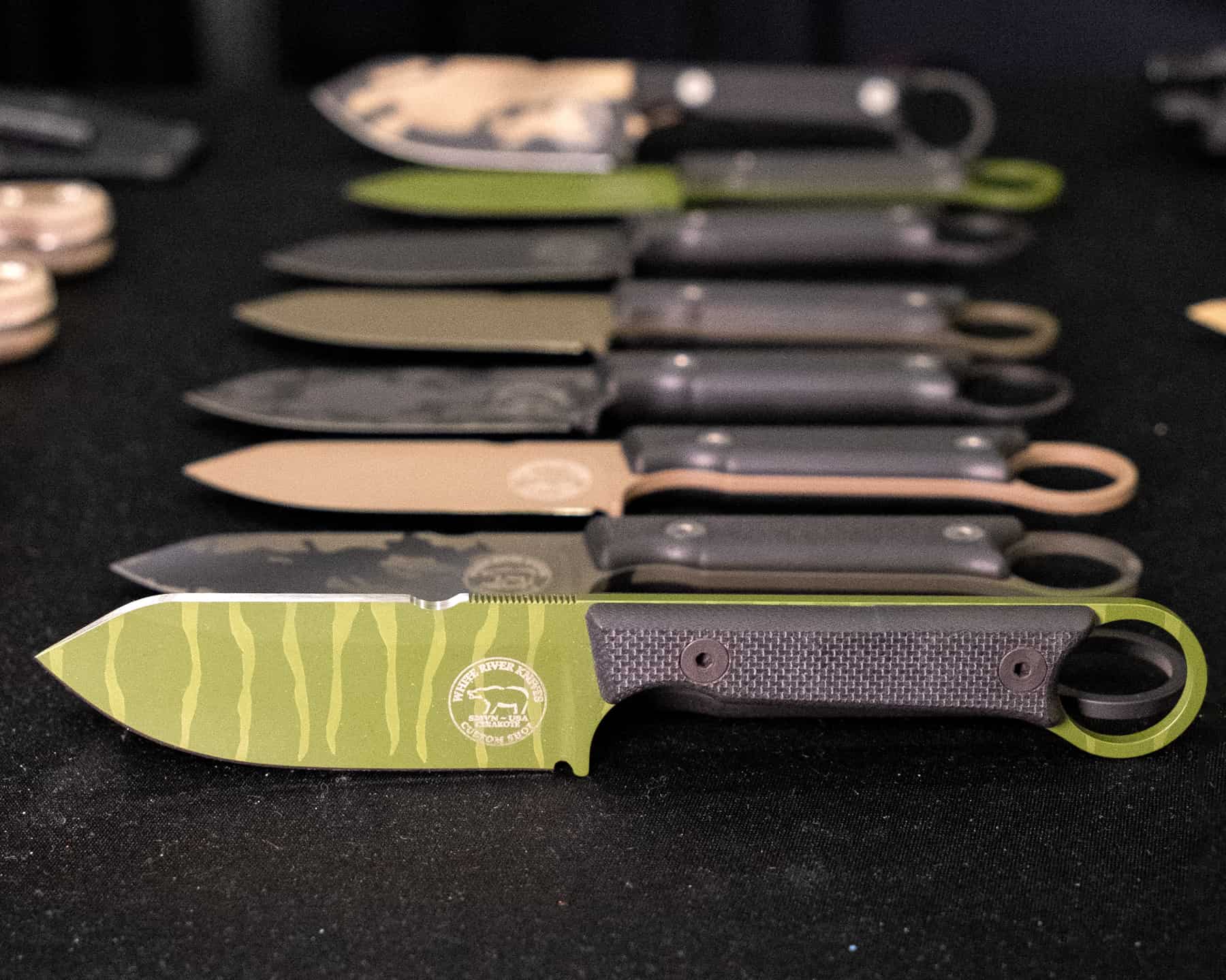 Colorful Cerakote designs of the White River Knives Firecraft 3.5.