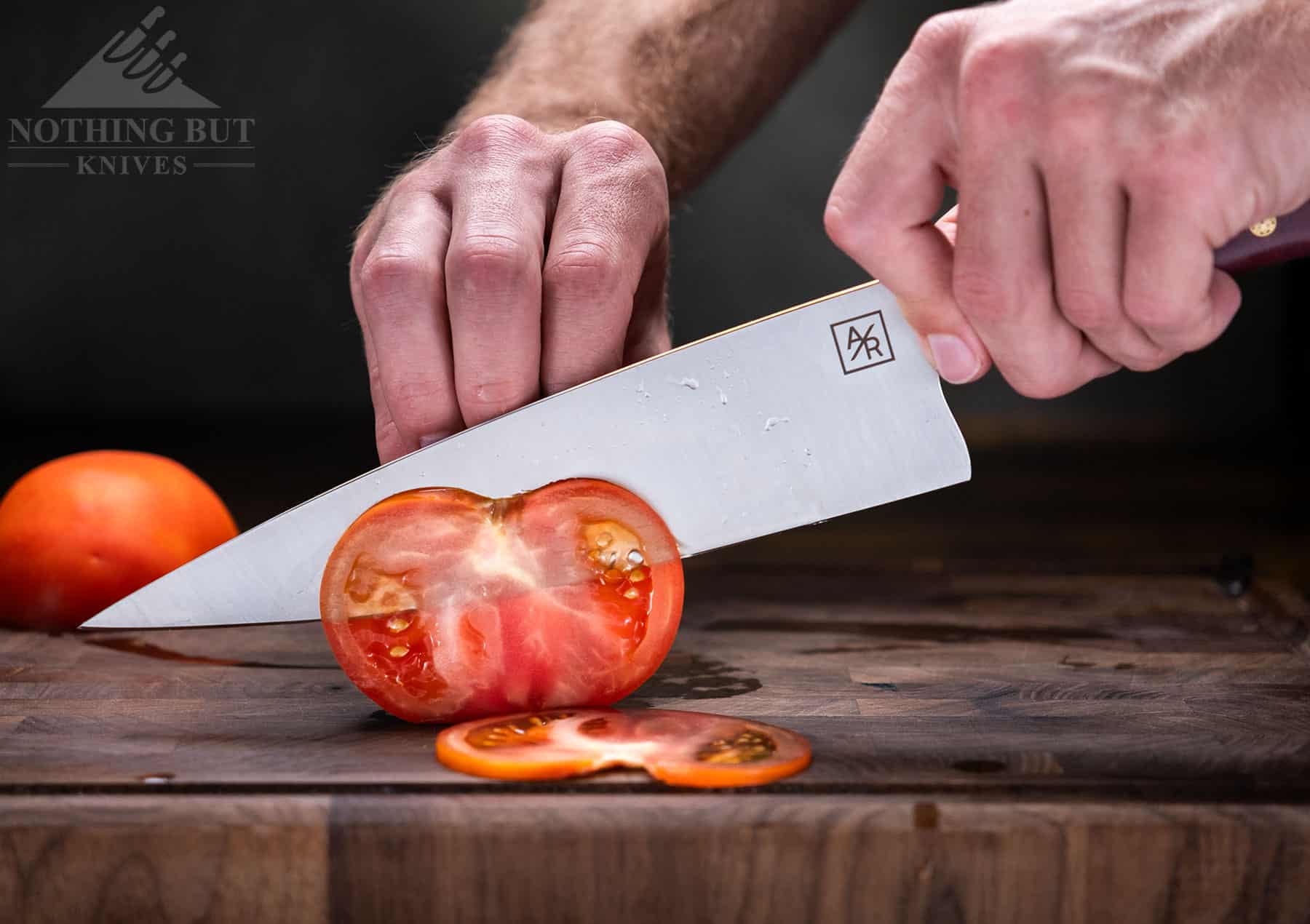 The Artisan Revere 8 inch chef knife easily cuts thin slices from a tomato. 