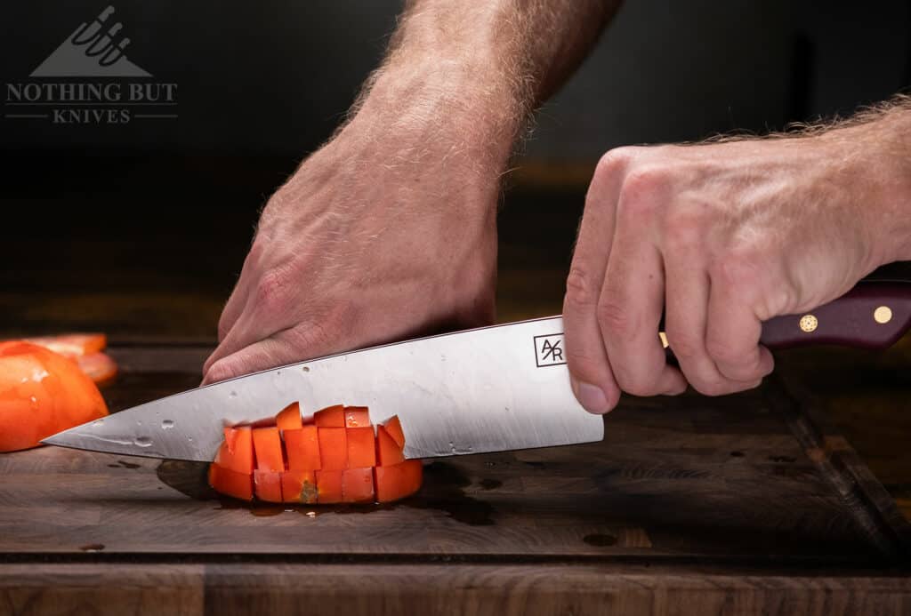 The first tomato I cut with this was just on the edge of going bad, but the edge sank in pretty easily, and it’s so thin that the blade started sinking down almost on its own weight.