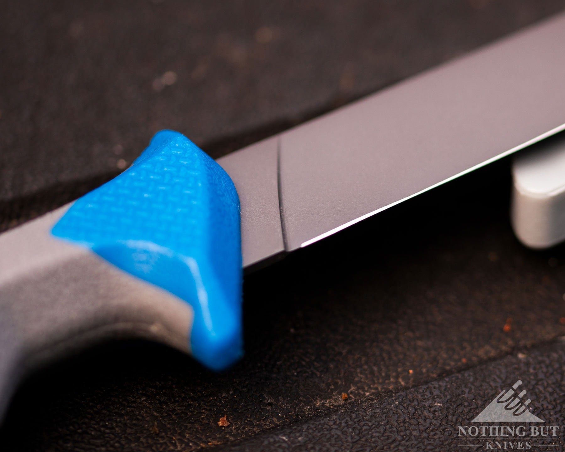 Buck Hookset fillet knife cutting edge and handle on leather surface