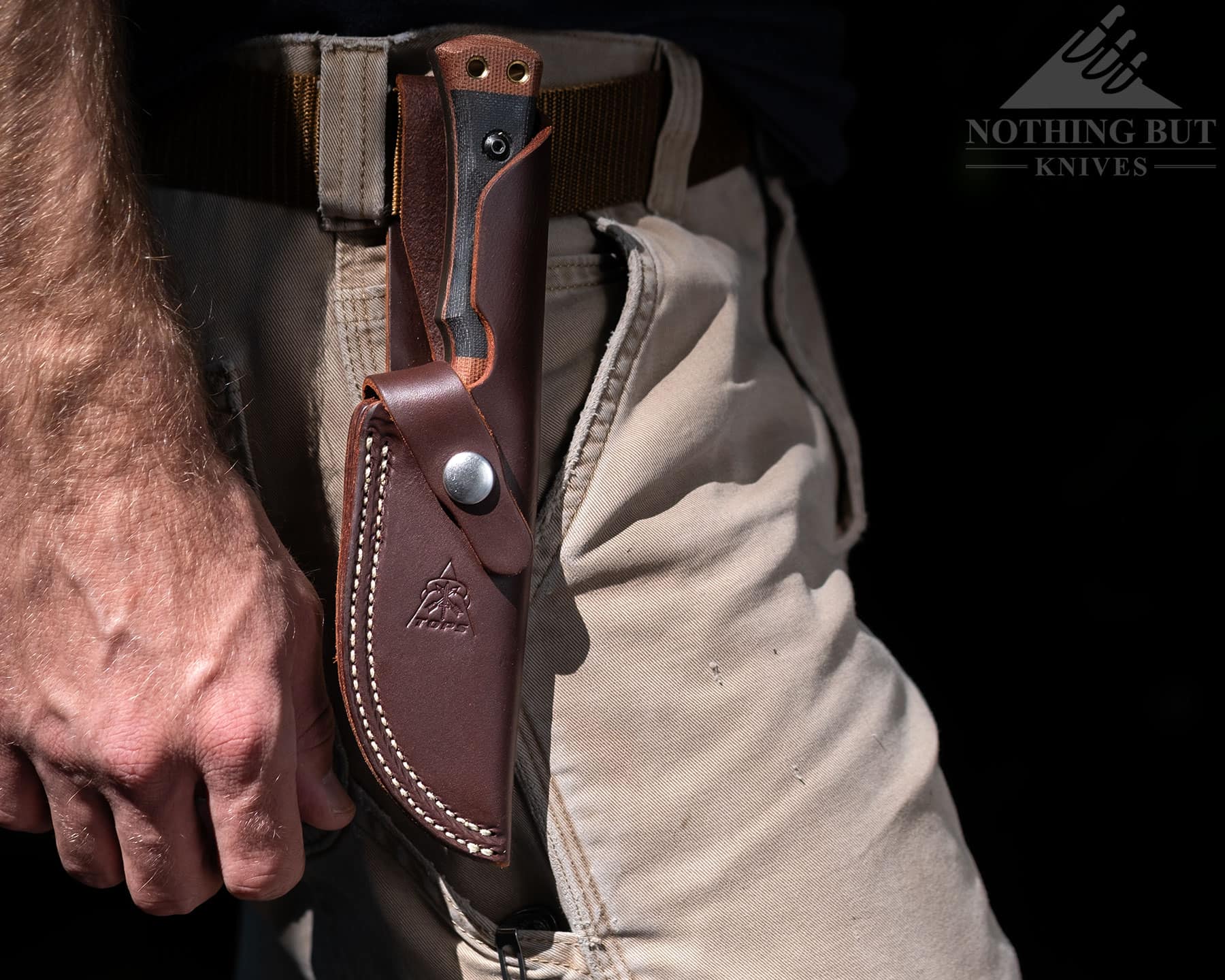 The leather Woodcraft sheath holds the knife in place well, but the retention strap is a bit unwieldy. 