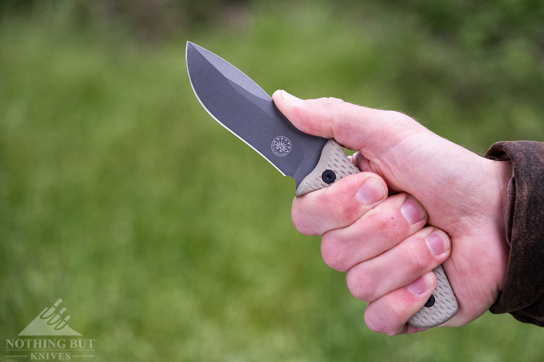 Off-Grid Sidekick Review - Image 3 A close-up of the Off-Grid Sidekick fixed blade knife being gripped in a person' right hand.
