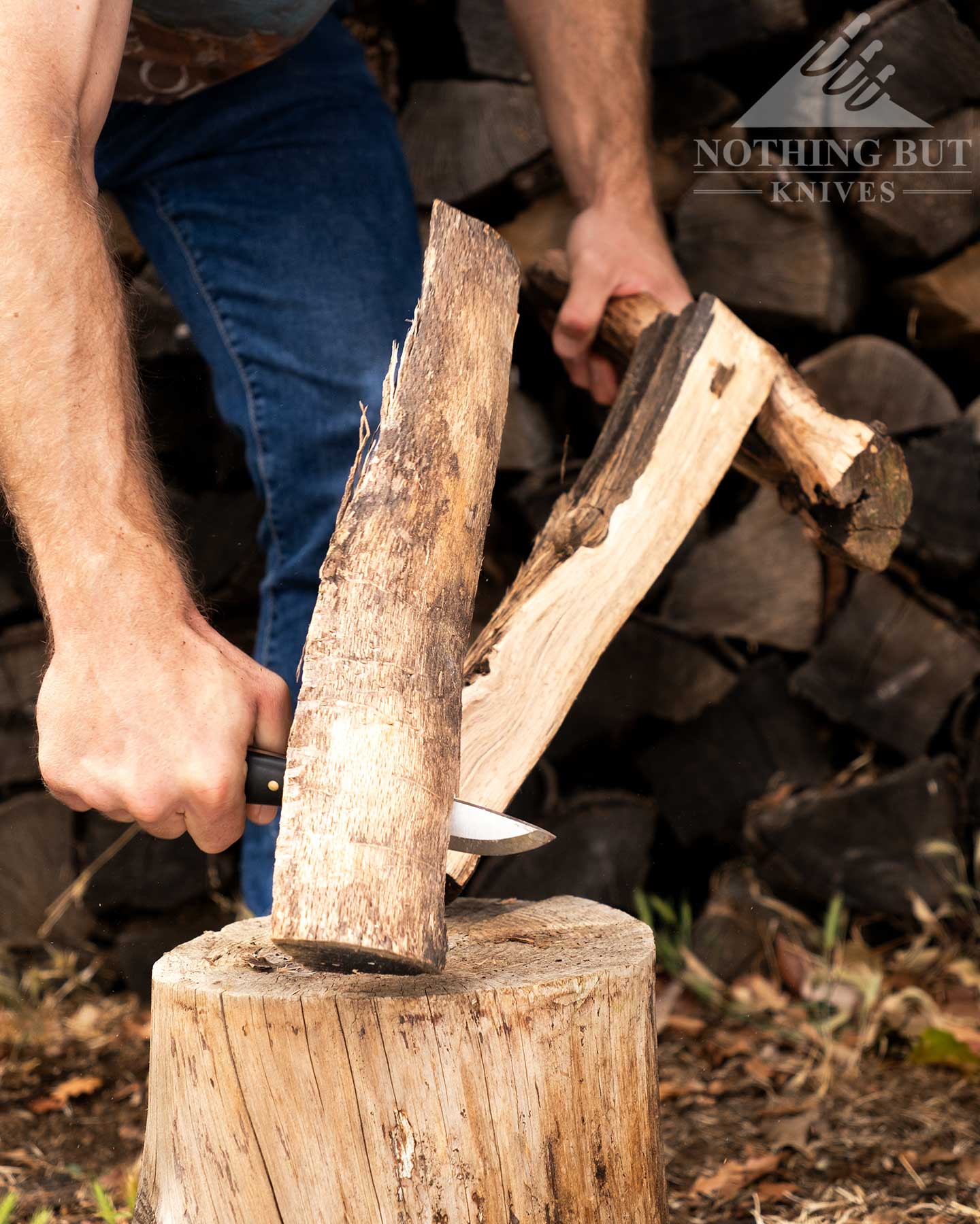 Boker Dbk Bushfriend 2000 Review - Image 11 An action shot of a piece of Oak firewood splitting apart after being batoned through with a bushcraft knife.