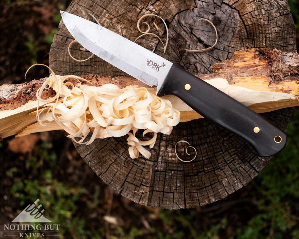Boker Dbk Bushfriend 2000 Review - Image 9 An overhead view of the Boker DBK Bushfriend 2000 fixed blade knife sitting on top of a feather stick it was used to carve.