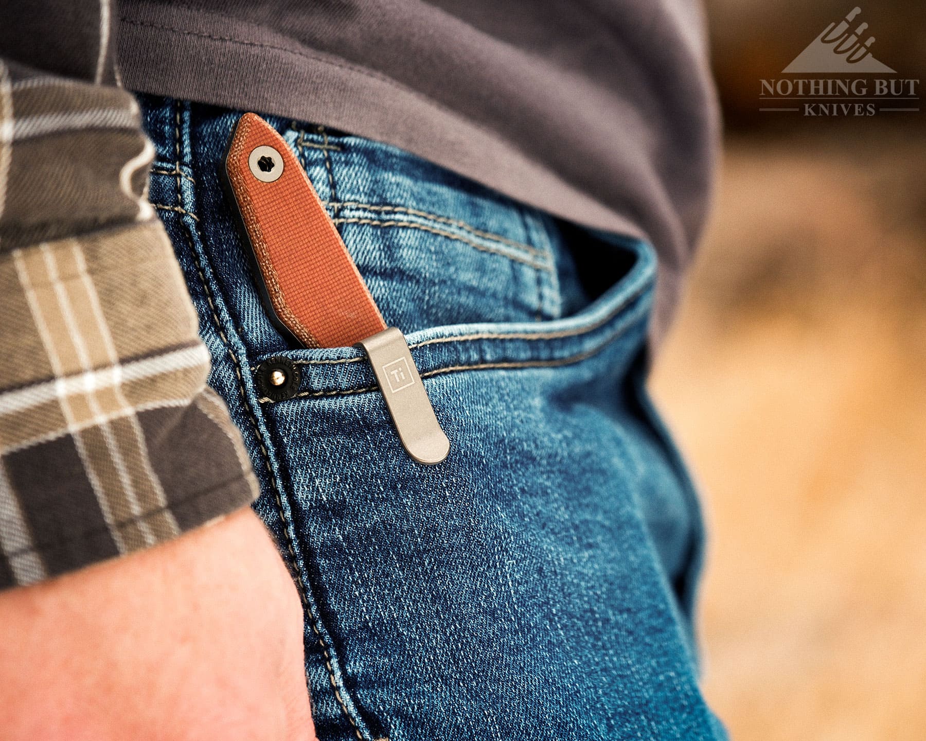 Our Favorite Fixed Blade Edc Knives And How To Carry Them - Image 10 The Big i Design fixed blade Overlook set up for everyday carry in the right front pocket of a person's jeans outdoors.