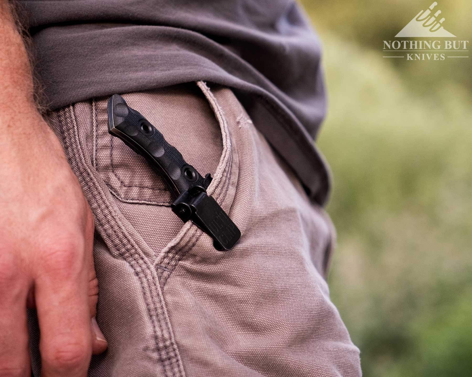 Our Favorite Fixed Blade Edc Knives And How To Carry Them - Image 6 A close-up of the T.Kell WharnEDC fixed blade knife clipped to a person's pocket in its kydex sheath.