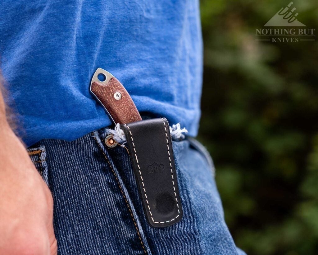 Our Favorite Fixed Blade Edc Knives And How To Carry Them - Image 8 The NKN POcket Tango in its magnetic leather sheath in a person's jeans pocket.