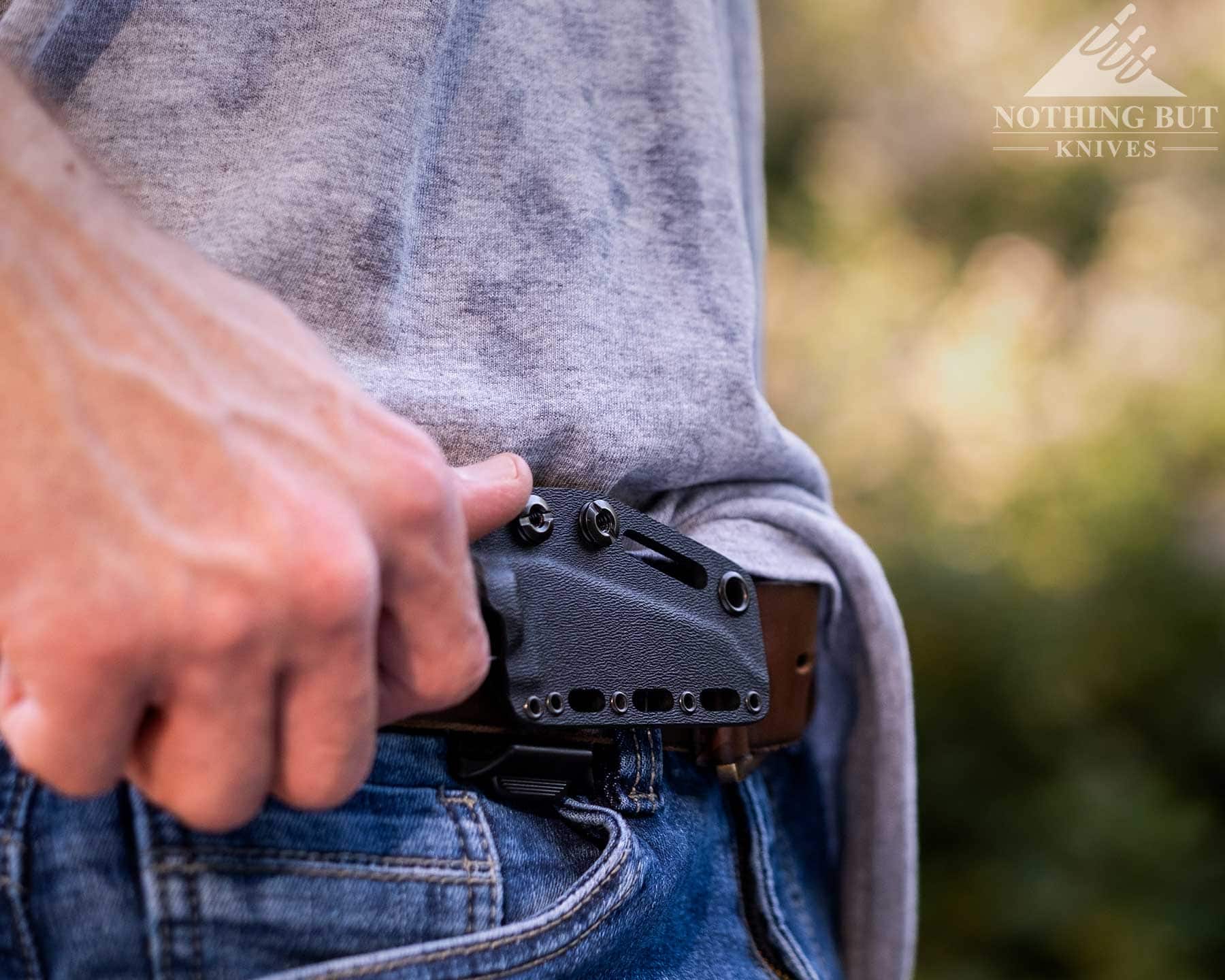 T.kell Wharnedc Review - Image 7 A close-up of the TKellEDC knife on a brown leather belt around a person's waist.