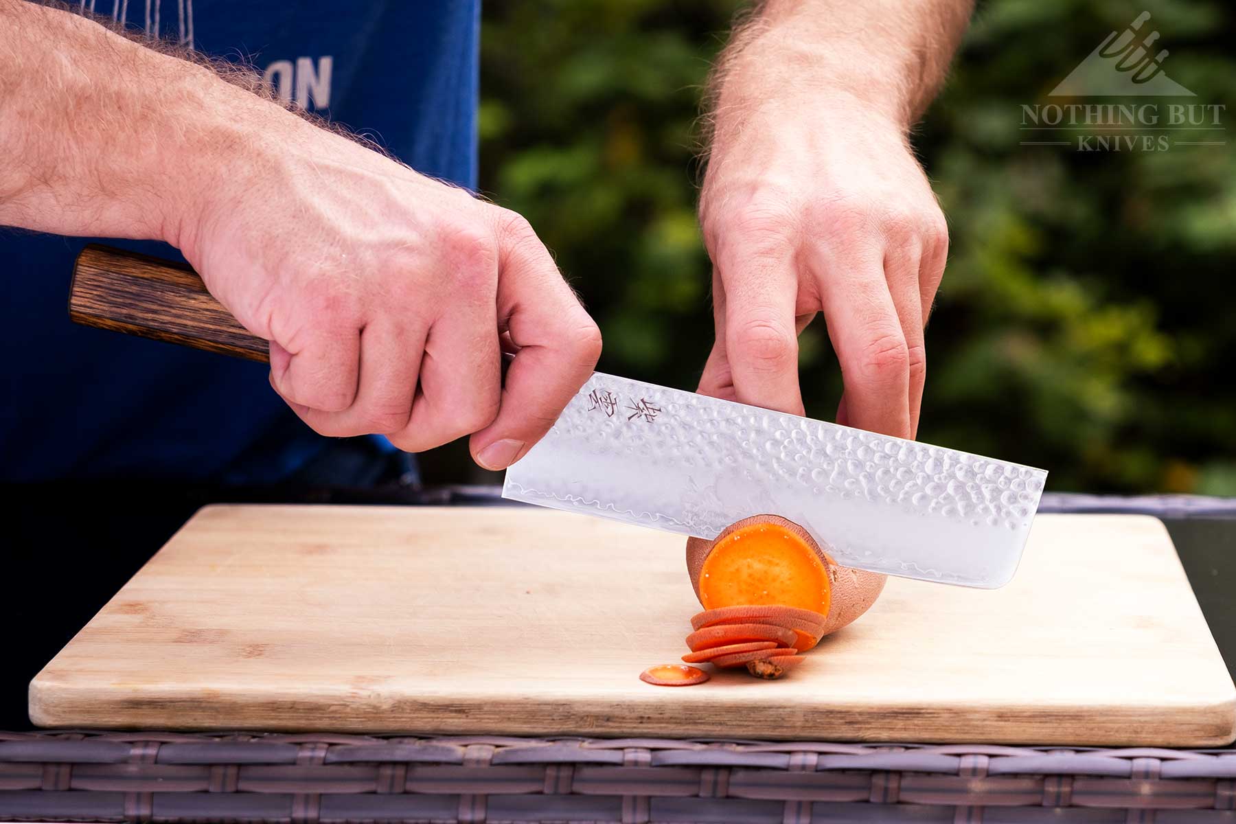 Demko Gyuto Chef Knife Review - Image 8 The Demko Knives Nakiri style cleaver being used to slice a sweet potato.