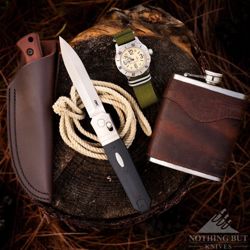 An overhead view of an old West style pocket dump of items on a tree stump