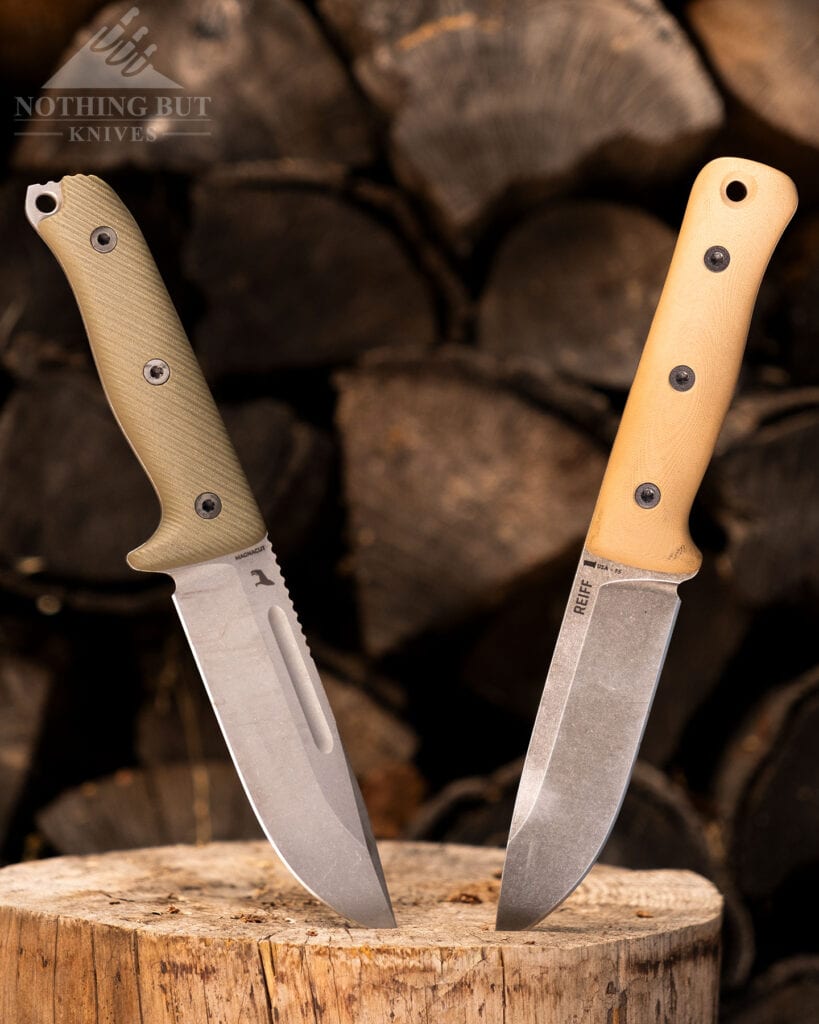 The Reiff Vicon (left) and the Reiff F5 Glider (right) with their blade tips sticking into a Pine round in front of a pile of firewood. 