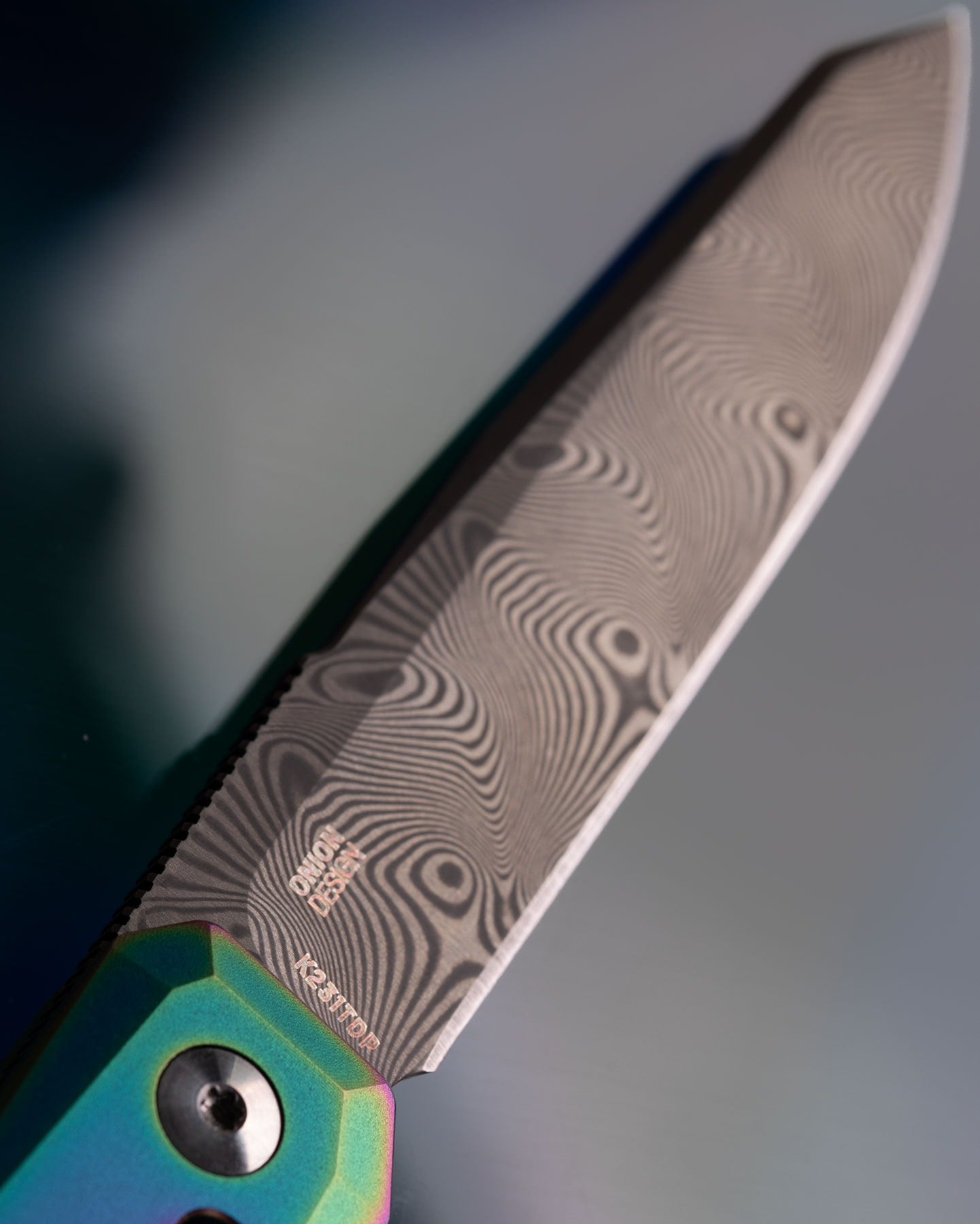 Crkt Releases New Pry Tool And Damascus Facet With New Colors - Image 2 A close-up[ of the 110 layer Damascus steel blade of the CRKT Facet.