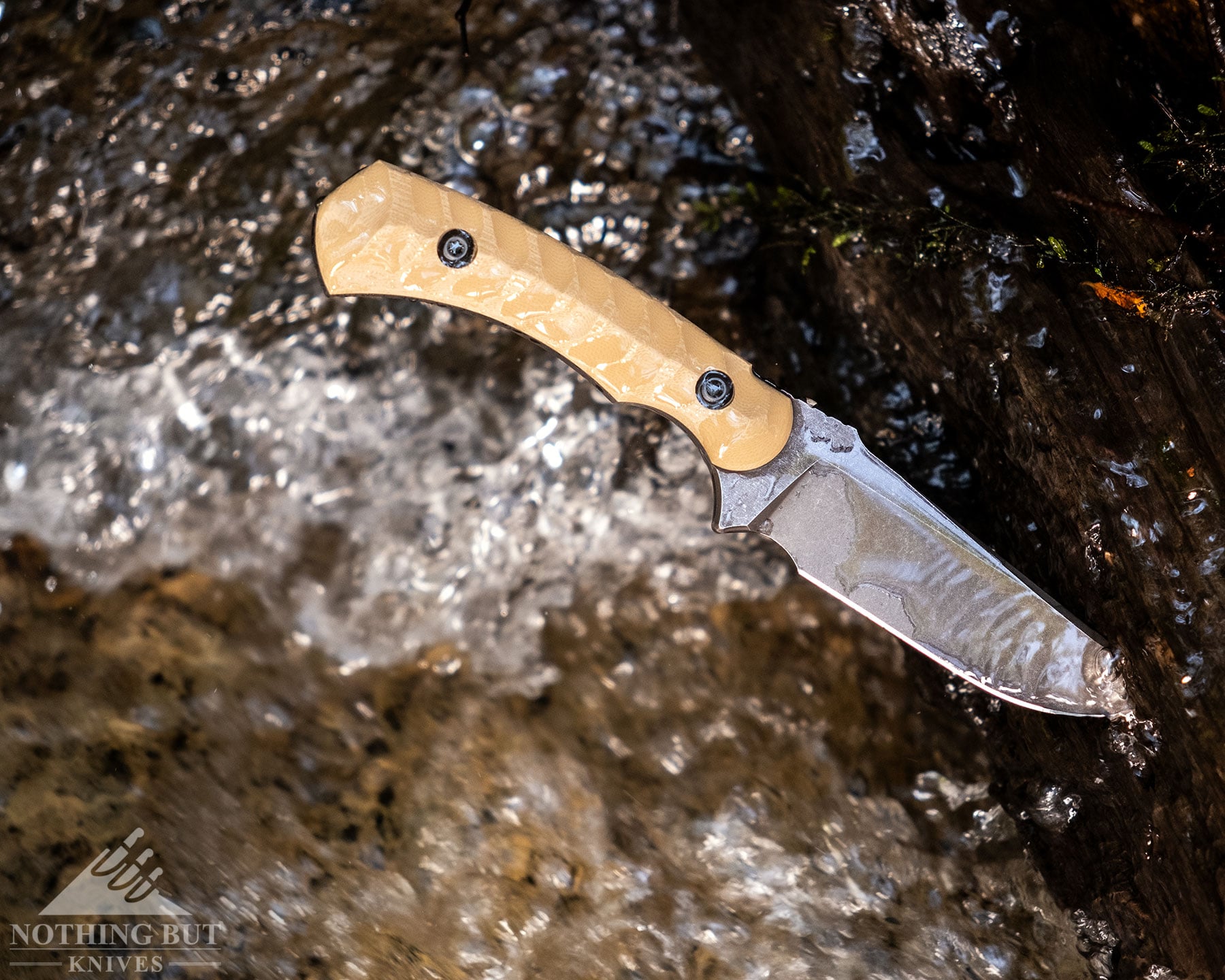 Toor Knives Brauler Review - Image 12 An overhead view of the Toor Brauler in the fast moving water of a mountain creek.