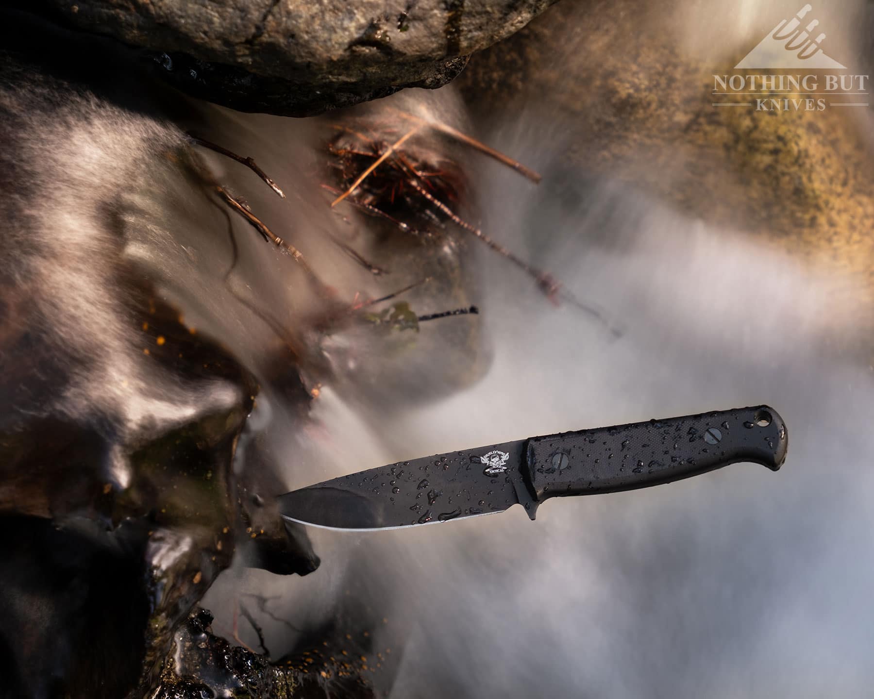 Skallywag Tactical. The Wanderer Review. - Image 13 Fixed blade coming out of a log in a creek