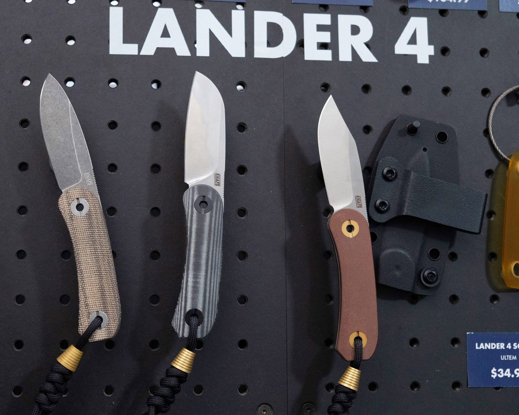 Blade Show West 2025 Wrap-Up - Image 14 The three versions of the Lander 4 fixed blade in the Knafs booth at Blade Show West.