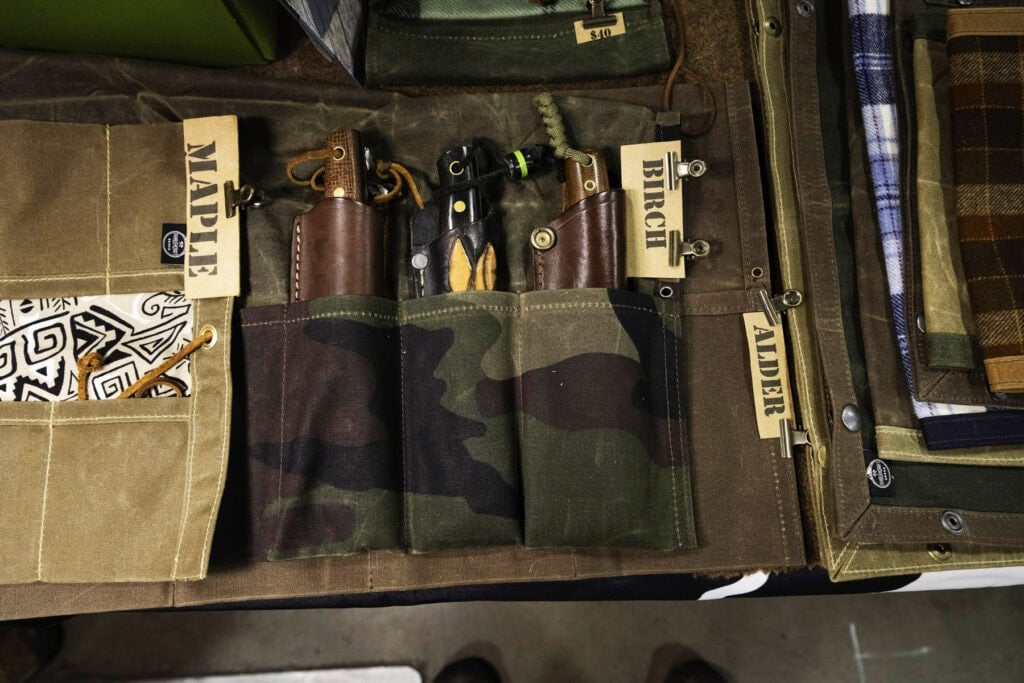 Blade Show West 2025 Wrap-Up - Image 11 An overhead view of waxed canvas knife rolls by PNW Bushcraft at Blade Show West.