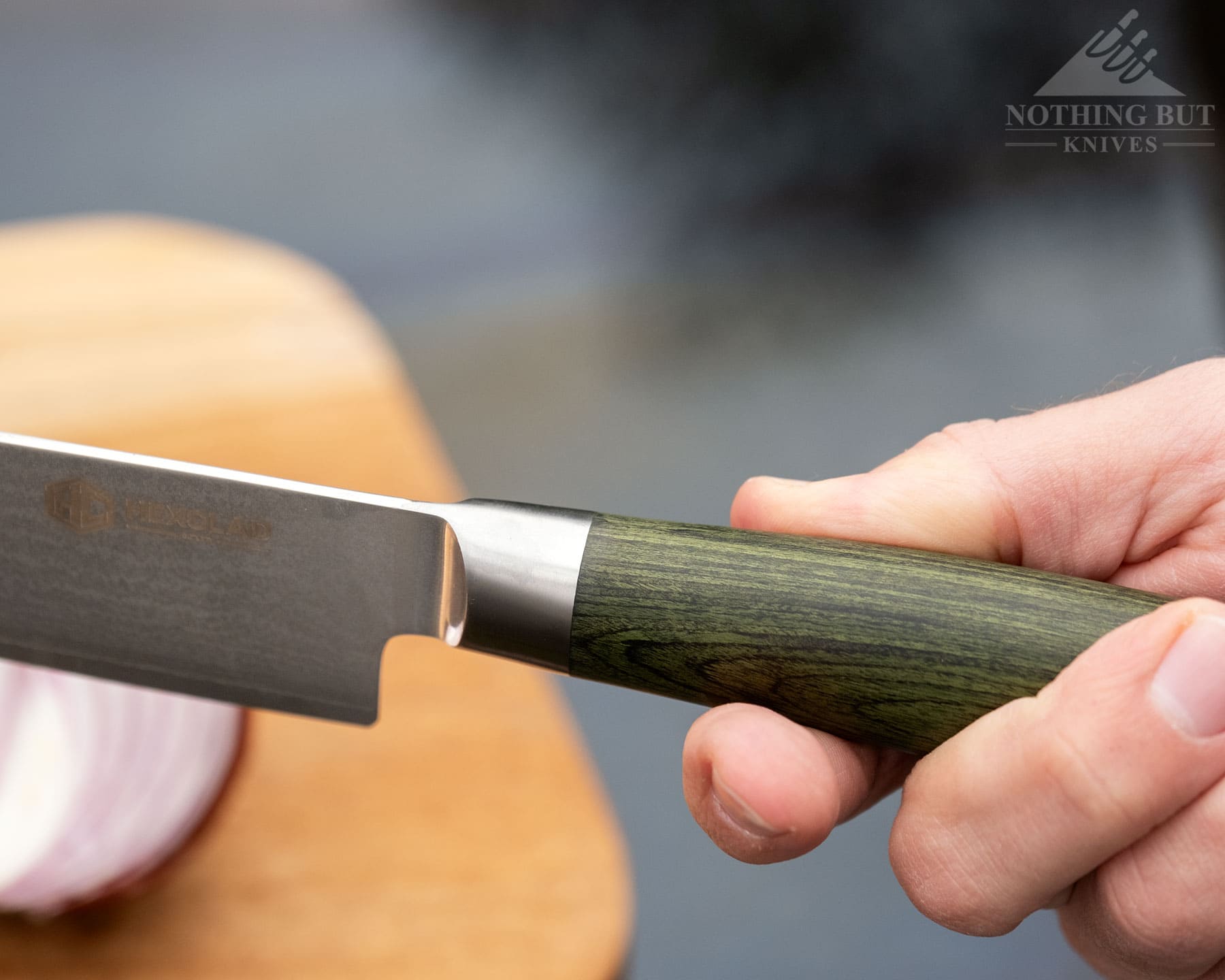 Hexclad Chef Knife Review - Is It Just Marketing Hype? - Image 5 A close-up of the top of the HexClad chef knife handle being held in a person's hand.