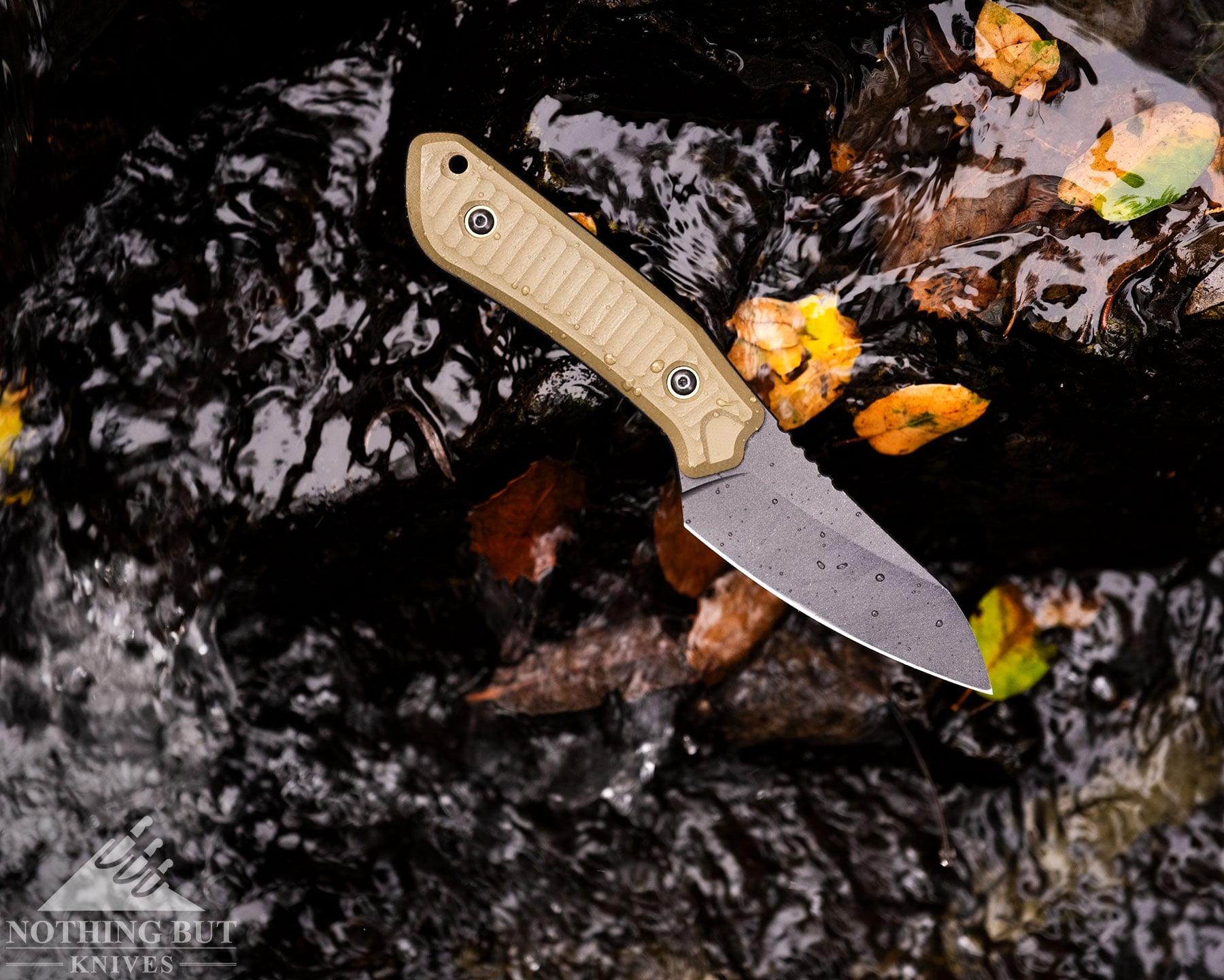 Schwarz Knives Overland X Review - Image 3 An overhead view of the Schwarz KNives Overland X balanced on a rock next to a mountain creek.