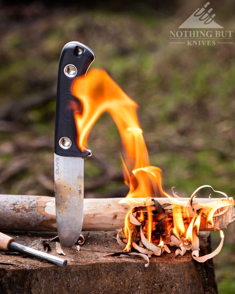 Olive Arbor Review - Image 16 The Olive Arbor next to a feather stick that is on fire.