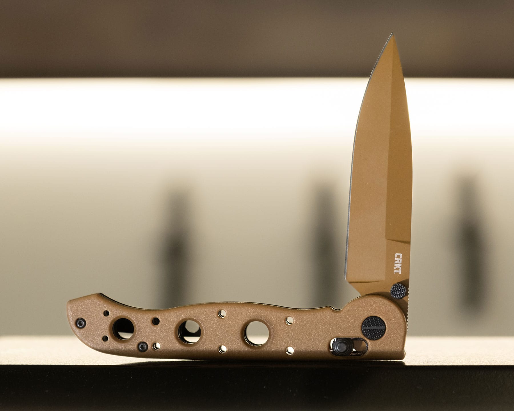 A side profile view of the cross bar lock version of the CRKT M-16 folding knife with the blade in the half open position. 