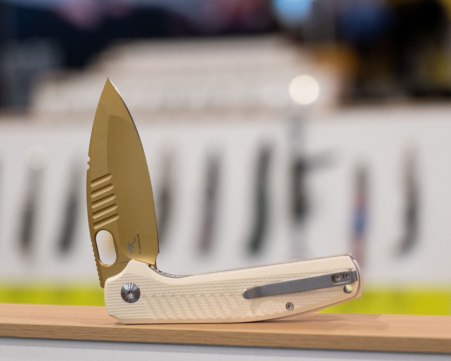 The Civivi Spooky pocket knife shown here with the blade in the half open position on a display case. 