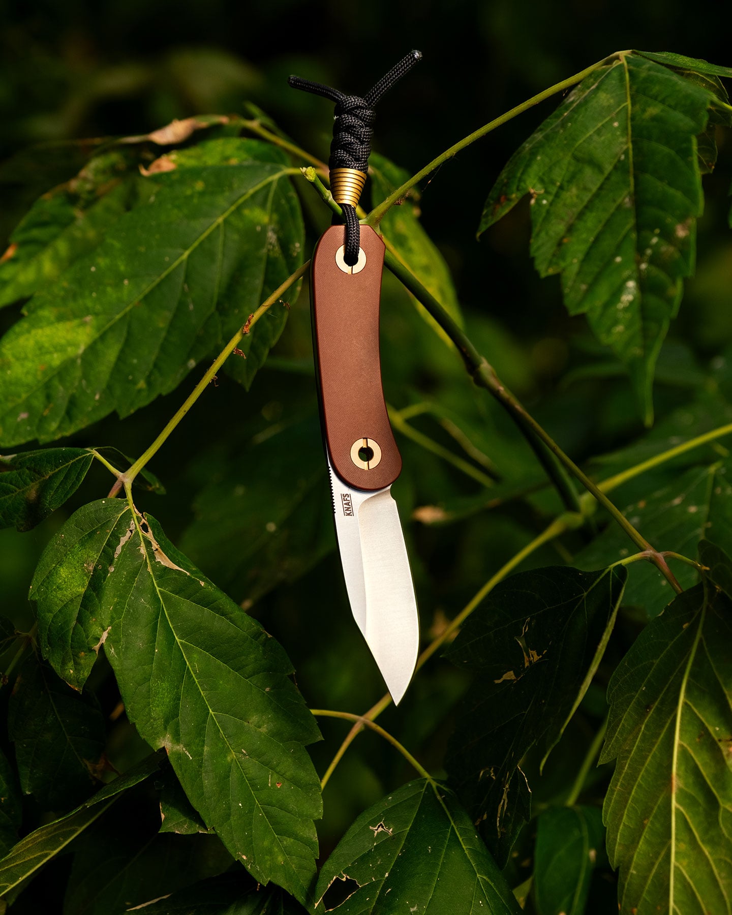 Blades N' Tales: Looking Inside The Knafs Rocket Ship - Image 11 The Knafs Lander 4 hanging from a branch among large green leaves outdoors.