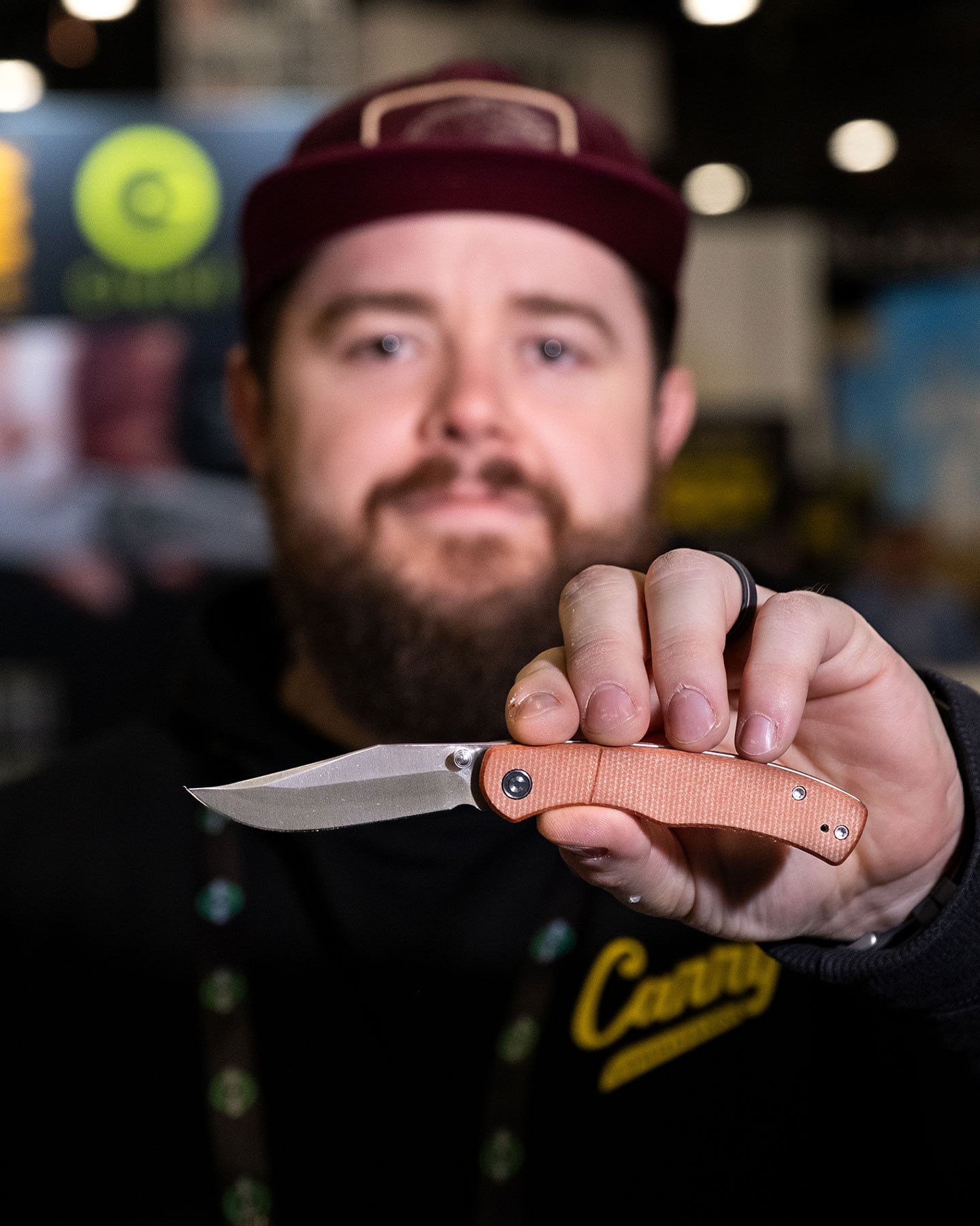 A shallow depth of field image showing Taylor Marin holding the Civivi Clingman folding knife.
