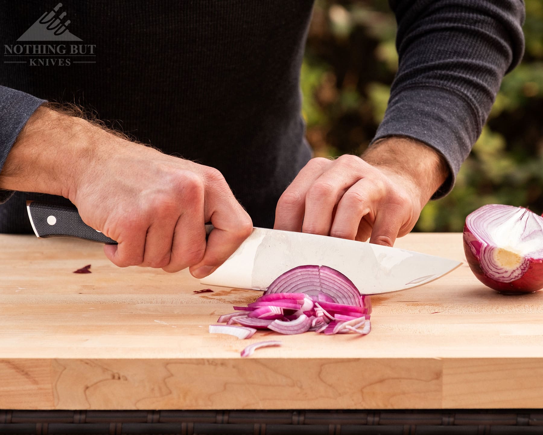 Zwilling Spectrum Chef'S Knife Review - Image 1 The Zwilling Spectrum Chef Knife dicing an onion on a cutting board.