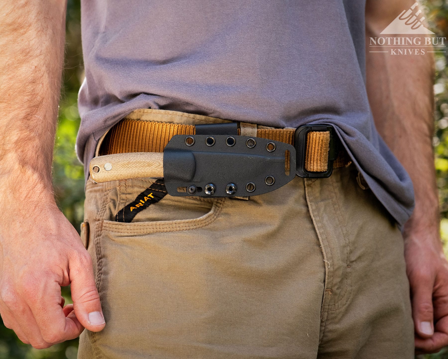 Knafs Lulu Review - Image 6 The Knafs Lulu horizontally carried on a mans belt loop in khaki pants with the forest in the background.