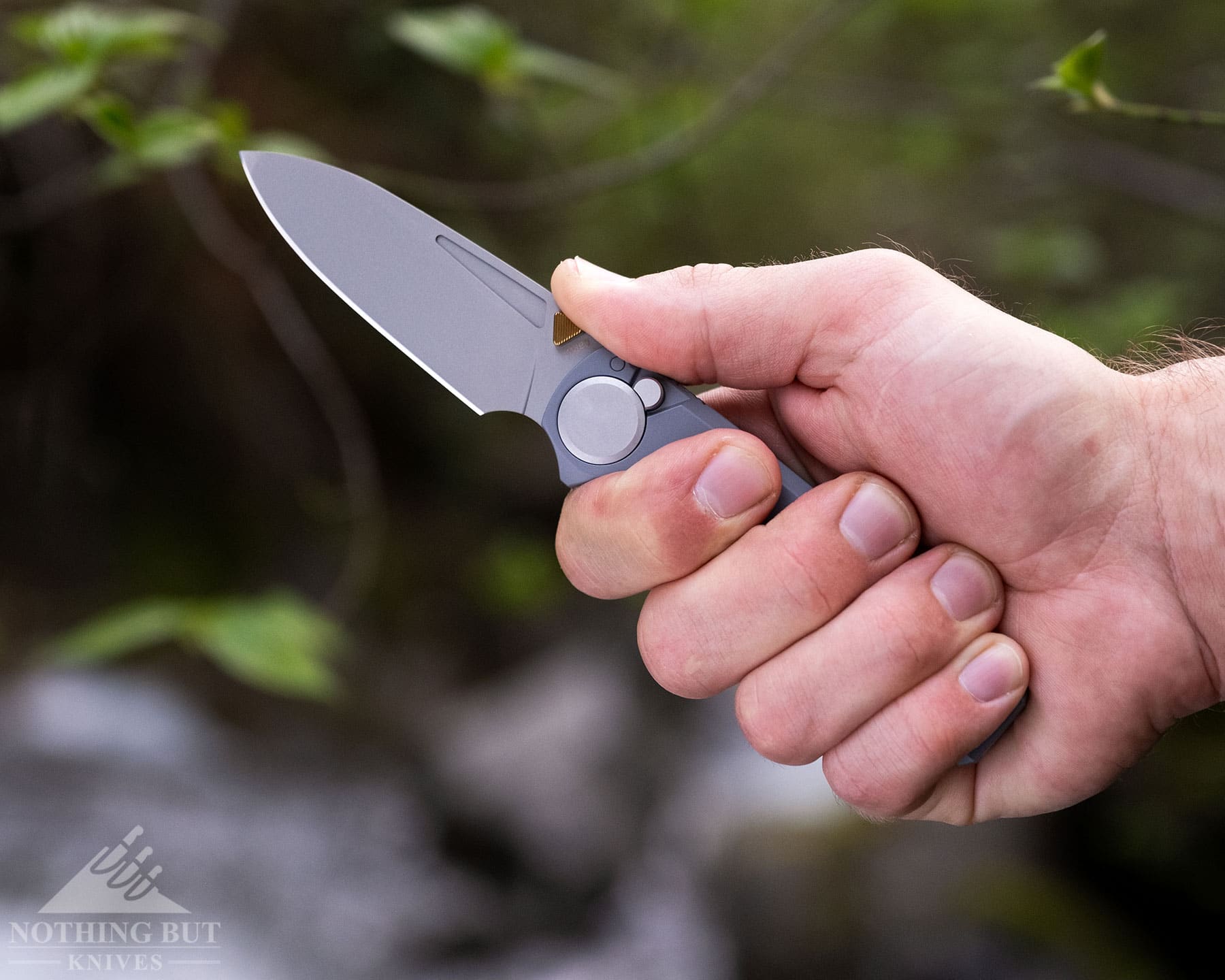 Worksharp Rmx Thumbstud Knife Review - Image 8 A close-up of the Work Sharp RMX folding knife being held in a person's hand with the knife's left profile facing the camera.