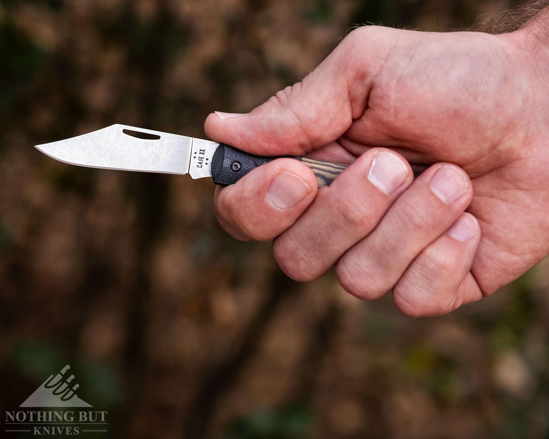 The Case Crossroads knife being gripped in a person's right hand to test handle ergonomics. 