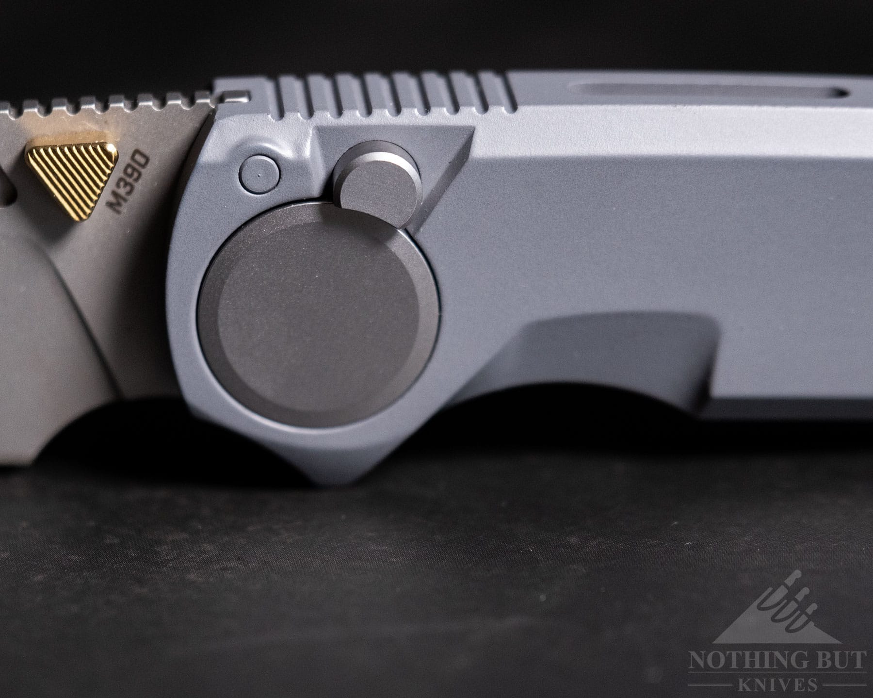 Worksharp Rmx Thumbstud Knife Review - Image 5 A close-up image pf the Work Sharp RMC folding knife button lock and pivot on a black background.