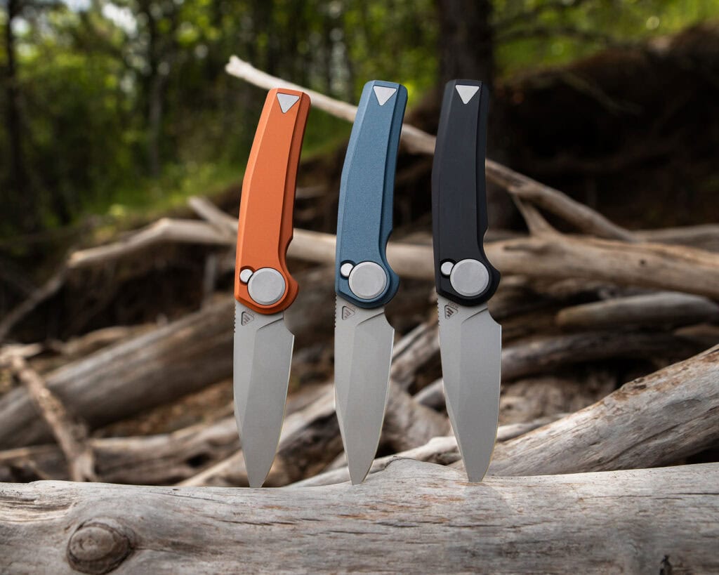 Three different color versions of the Work Sharp Madrone sticking out of a log in the forest.