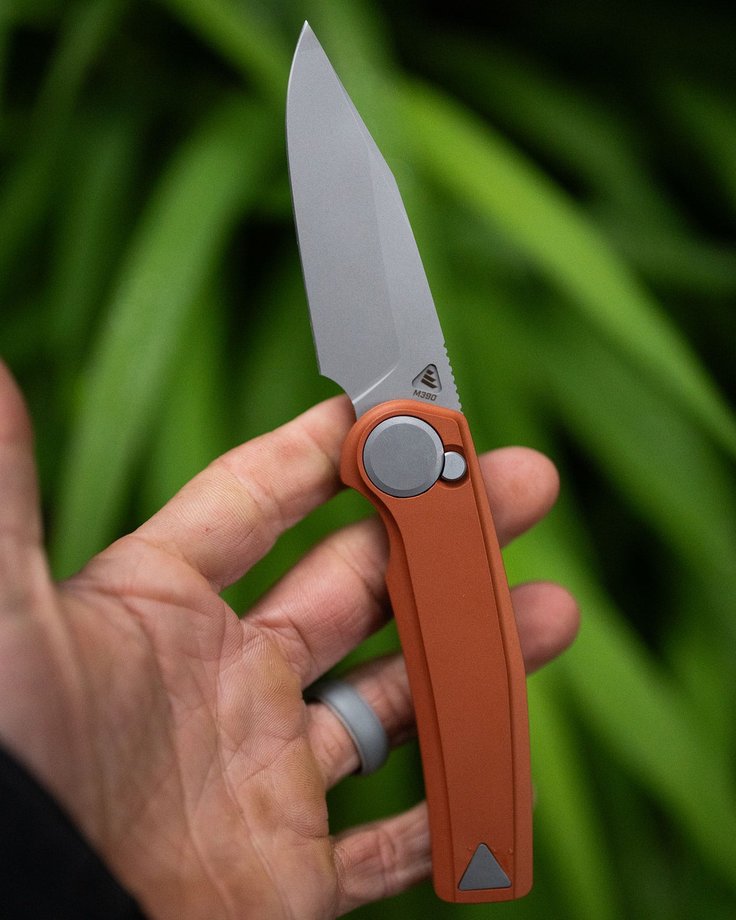 An overhead image of the Work Sharp Madrone with the blade in the open position on a person's open hand.