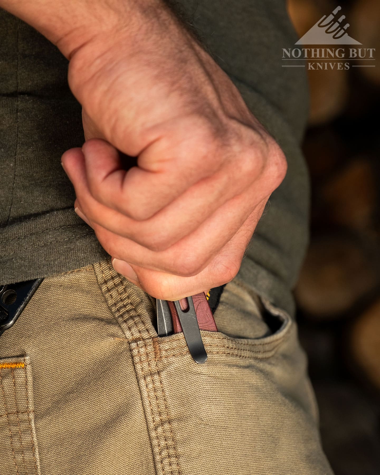 Hogue Mysto Review - Image 10 A pocketknife being deployed from a right front pants pocket.